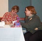 Laura signs a book for Jennifer Stevenson at the Chicago area 2003 All For Love event, which raised over $2100 for the American Heart Association.	