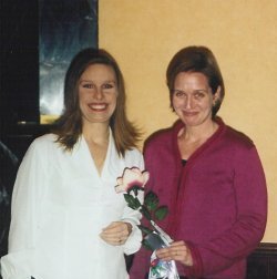 Laura (right) accepts a rose from Chicago-North president Deb Rittle, signifying the sale of Night Swimming to Ivy Books in 2002.